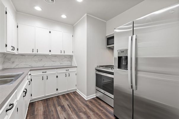 Interior, Kitchen, Marble Walls, Recessed Lighting, Stainless Steel Appliances, Wood Texture Flooring