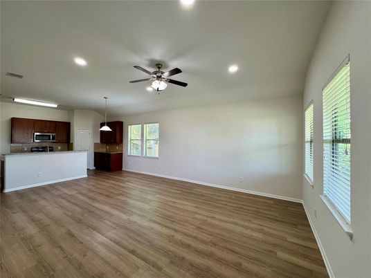 Empty room, Interior, Kitchen, Pendant Lights, Recessed Lighting, Stainless Steel Appliances, Wood Texture Flooring