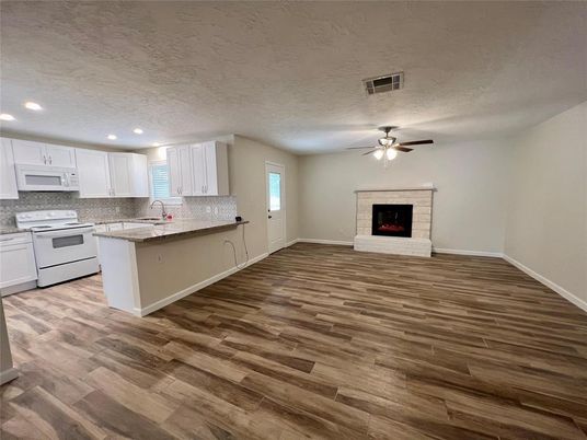 Empty room, Fireplace, Interior, Kitchen, Recessed Lighting, Wood Texture Flooring