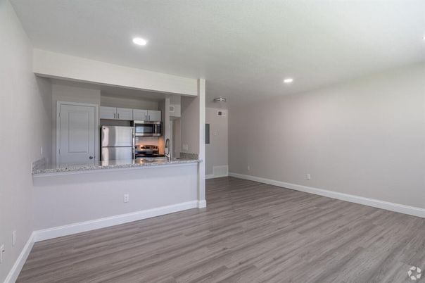 Empty room, Interior, Kitchen, Recessed Lighting, Stainless Steel Appliances, Wood Texture Flooring