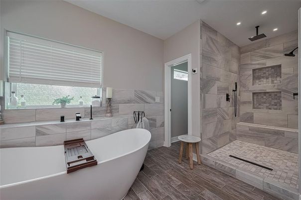 Bathroom, Free Standing Baths, Glass Shower, Interior, Marble Walls, Recessed Lighting, Wood Texture Flooring