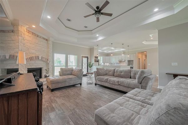 Fireplace, Interior, Kitchen, Living room, Pendant Lights, Recessed Lighting, Stainless Steel Appliances, Stone Walls, Wood Texture Flooring