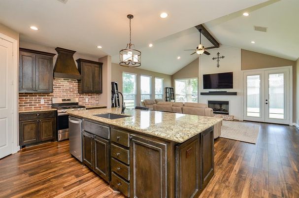 Fireplace, Interior, Kitchen, Living room, Pendant Lights, Recessed Lighting, Stainless Steel Appliances, Stone Walls, Wood Texture Flooring