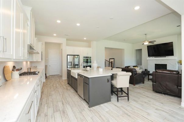 Fireplace, Interior, Kitchen, Living room, Recessed Lighting, Stainless Steel Appliances, Wood Texture Flooring