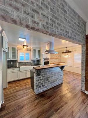Interior, Kitchen, Pendant Lights, Stainless Steel Appliances, Stone Walls, Wood Texture Flooring