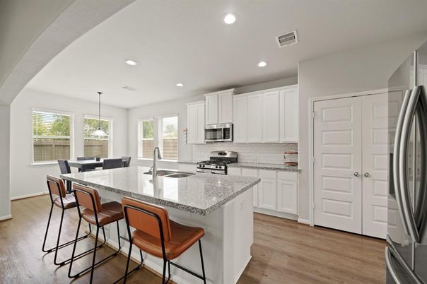 Dining room, Interior, Kitchen, Pendant Lights, Recessed Lighting, Stainless Steel Appliances, Wood Texture Flooring