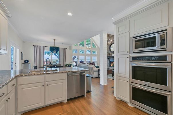 Fireplace, Interior, Kitchen, Living room, Recessed Lighting, Stainless Steel Appliances, Wood Texture Flooring