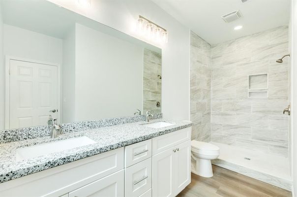 Bathroom, Dual Sink Vanities, Interior, Marble Walls, Recessed Lighting, Wood Texture Flooring