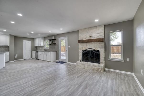 Empty room, Fireplace, Interior, Kitchen, Recessed Lighting, Stone Walls, Wood Texture Flooring