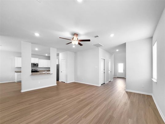 Empty room, Interior, Kitchen, Recessed Lighting, Stainless Steel Appliances, Wood Texture Flooring