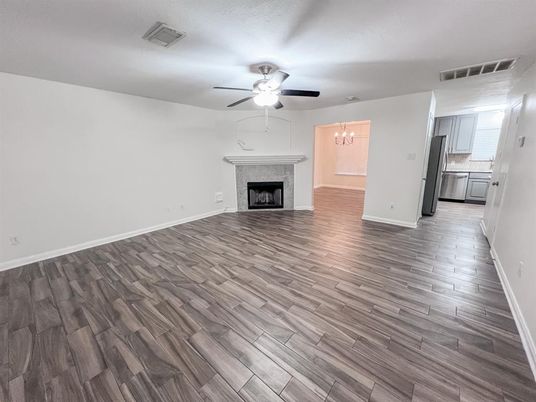 Chandelier, Empty room, Fireplace, Interior, Kitchen, Stainless Steel Appliances, Wood Texture Flooring