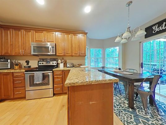 Chandelier, Dining room, Interior, Kitchen, Pendant Lights, Recessed Lighting, Stainless Steel Appliances, Wood Texture Flooring
