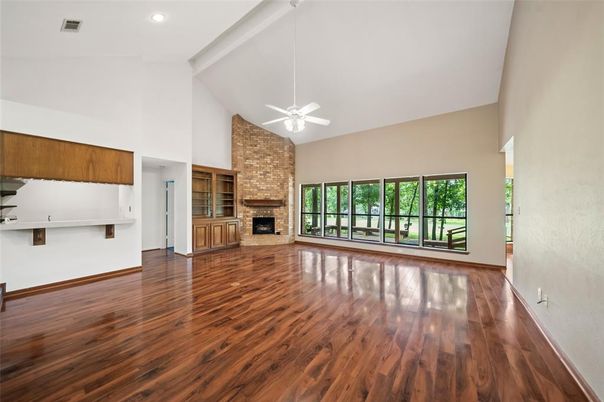 Empty room, Fireplace, Interior, Recessed Lighting, Stone Walls, Wood Texture Flooring