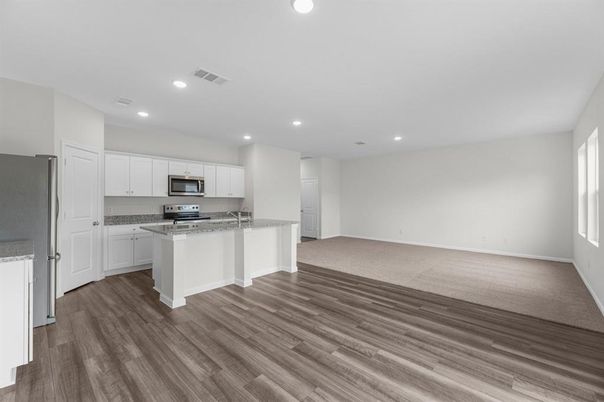 Empty room, Interior, Kitchen, Recessed Lighting, Stainless Steel Appliances, Wood Texture Flooring