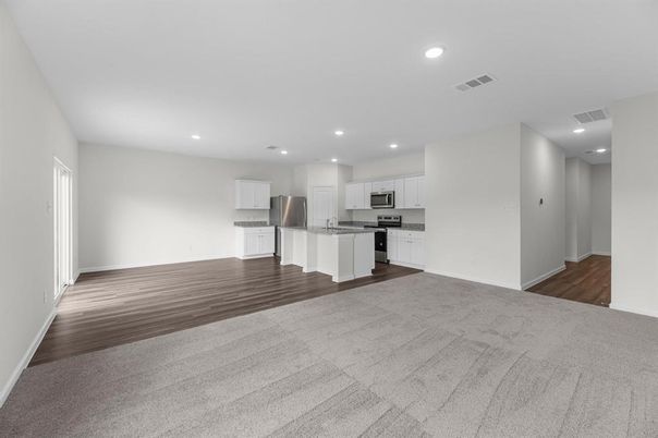 Empty room, Interior, Kitchen, Recessed Lighting, Stainless Steel Appliances, Wood Texture Flooring