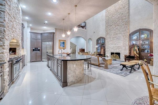 Fireplace, Interior, Kitchen, Living room, Pendant Lights, Recessed Lighting, Stainless Steel Appliances, Stone Walls