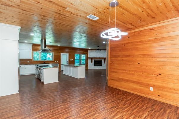 Empty room, Fireplace, Interior, Kitchen, Pendant Lights, Recessed Lighting, Wooden Ceilings, Wood Texture Flooring, Wooden Walls