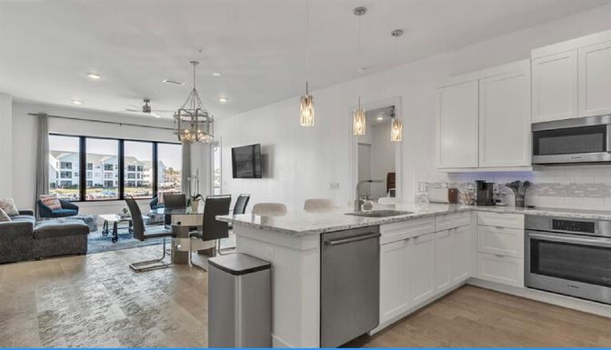 Chandelier, Dining room, Interior, Kitchen, Living room, Pendant Lights, Recessed Lighting, Stainless Steel Appliances, Wood Texture Flooring