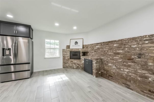 Empty room, Fireplace, Interior, Kitchen, Recessed Lighting, Stainless Steel Appliances, Stone Walls, Wood Texture Flooring