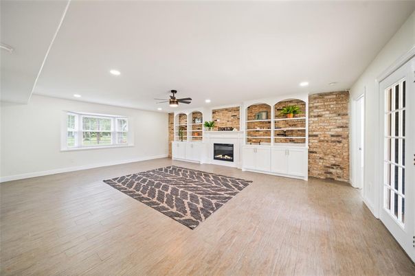 Empty room, Fireplace, Interior, Recessed Lighting, Stone Walls, Wood Texture Flooring