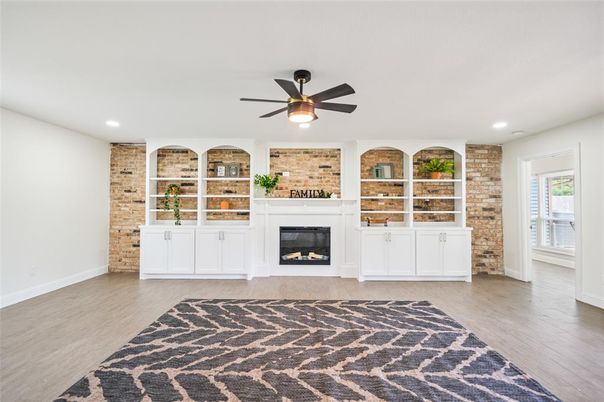 Empty room, Fireplace, Interior, Recessed Lighting, Stone Walls, Wood Texture Flooring
