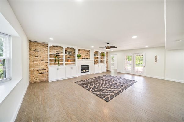 Empty room, Fireplace, Interior, Recessed Lighting, Stone Walls, Wood Texture Flooring