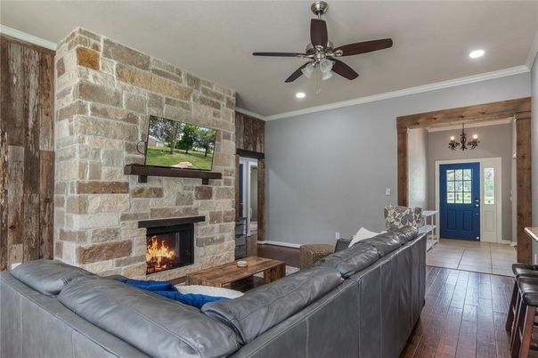 Chandelier, Fireplace, Interior, Living room, Recessed Lighting, Stone Walls, Wood Texture Flooring