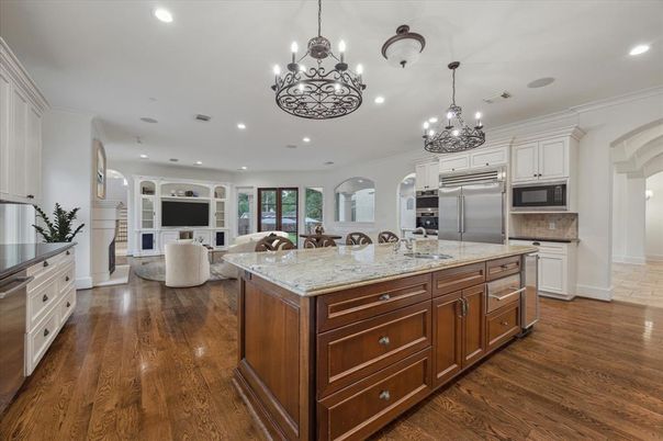 Chandelier, Interior, Kitchen, Living room, Pendant Lights, Recessed Lighting, Stainless Steel Appliances, Wood Texture Flooring