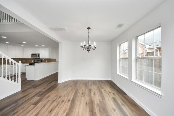 Chandelier, Empty room, Interior, Kitchen, Recessed Lighting, Stainless Steel Appliances, Wood Texture Flooring