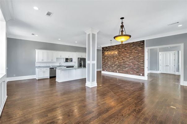 Empty room, Interior, Kitchen, Pendant Lights, Recessed Lighting, Stainless Steel Appliances, Stone Walls, Wood Texture Flooring