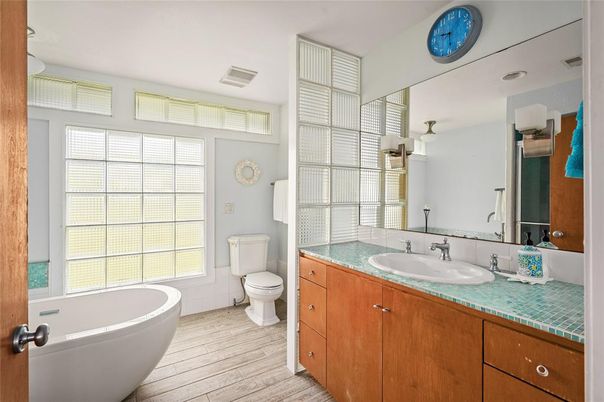Bathroom, Dual Sink Vanities, Free Standing Baths, Interior, Tile Countertops, Wood Texture Flooring