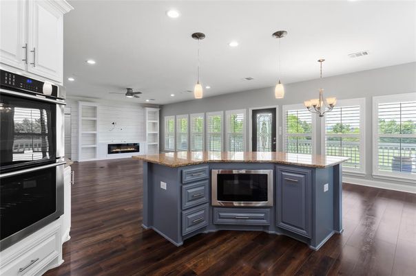 Chandelier, Fireplace, Interior, Kitchen, Pendant Lights, Recessed Lighting, Stainless Steel Appliances, Wood Texture Flooring