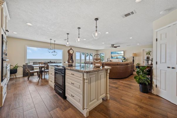 Dining room, Interior, Kitchen, Living room, Pendant Lights, Recessed Lighting, Water, Wood Texture Flooring
