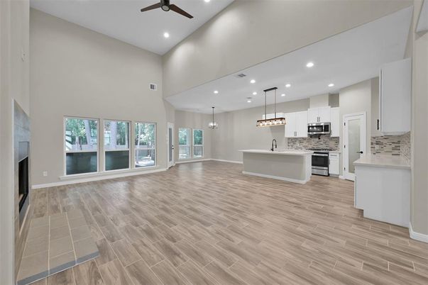 Empty room, Interior, Kitchen, Pendant Lights, Recessed Lighting, Stainless Steel Appliances, Wood Texture Flooring