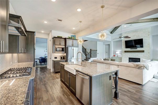 Fireplace, Interior, Kitchen, Living room, Pendant Lights, Recessed Lighting, Stainless Steel Appliances, Stone Walls, Wood Texture Flooring