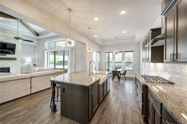 Chandelier, Dining room, Interior, Kitchen, Living room, Pendant Lights, Recessed Lighting, Stainless Steel Appliances, Wood Texture Flooring