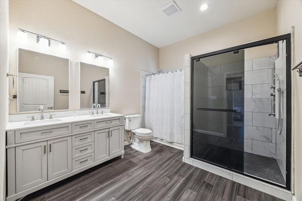 Bathroom, Dual Sink Vanities, Glass Shower, Interior, Recessed Lighting, Wood Texture Flooring