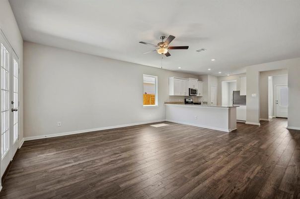 Empty room, Interior, Kitchen, Recessed Lighting, Stainless Steel Appliances, Wood Texture Flooring