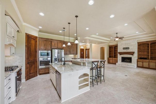 Fireplace, Interior, Kitchen, Pendant Lights, Recessed Lighting, Stainless Steel Appliances, Stone Walls