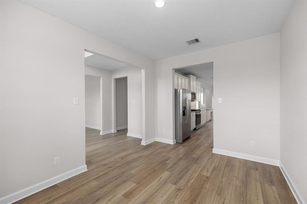 Empty room, Interior, Kitchen, Recessed Lighting, Stainless Steel Appliances, Wood Texture Flooring