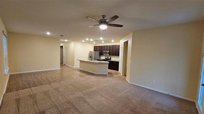 Empty room, Interior, Kitchen, Recessed Lighting, Stainless Steel Appliances, Wood Texture Flooring