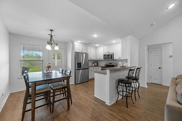 Dining room, Interior, Kitchen, Pendant Lights, Recessed Lighting, Stainless Steel Appliances, Wood Texture Flooring