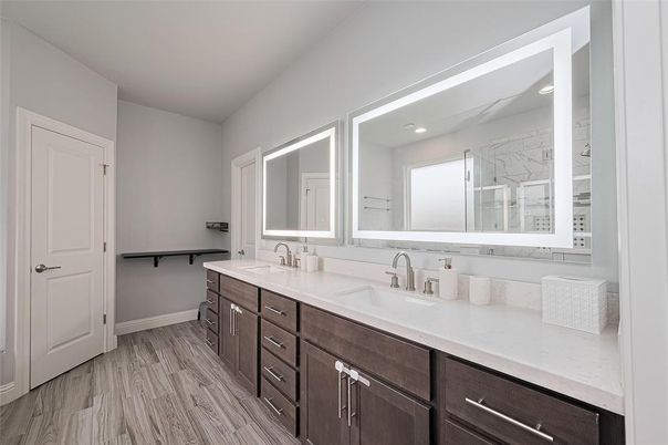 Bathroom, Dual Sink Vanities, Interior, Marble Walls, Recessed Lighting, Wood Texture Flooring
