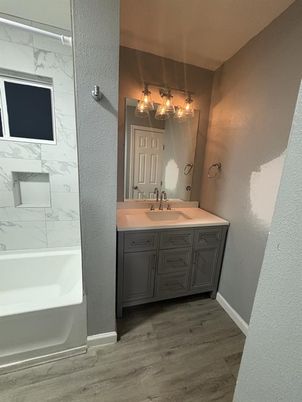 Bathroom, Dual Sink Vanities, Interior, Marble Walls, Wood Texture Flooring