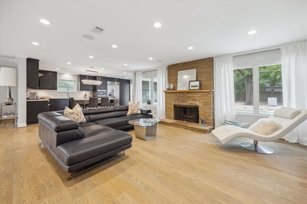 Fireplace, Interior, Kitchen, Living room, Pendant Lights, Recessed Lighting, Stainless Steel Appliances, Stone Walls, Wood Texture Flooring