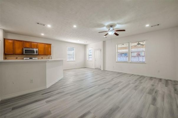 Empty room, Interior, Kitchen, Recessed Lighting, Stainless Steel Appliances, Wood Texture Flooring