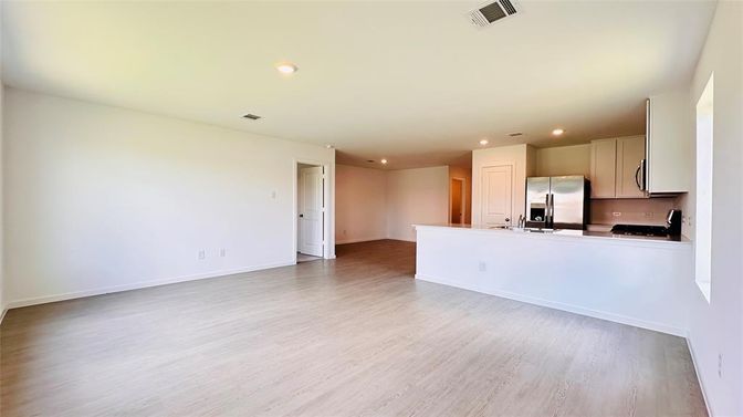 Empty room, Interior, Kitchen, Recessed Lighting, Stainless Steel Appliances, Wood Texture Flooring