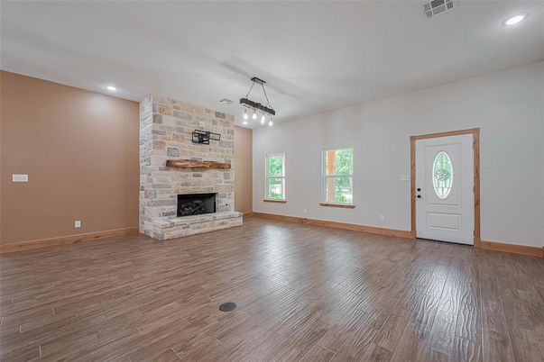 Empty room, Fireplace, Interior, Pendant Lights, Recessed Lighting, Stone Walls, Wood Texture Flooring
