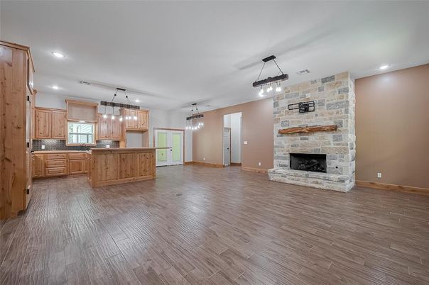 Empty room, Fireplace, Interior, Kitchen, Pendant Lights, Recessed Lighting, Stone Walls, Wood Texture Flooring