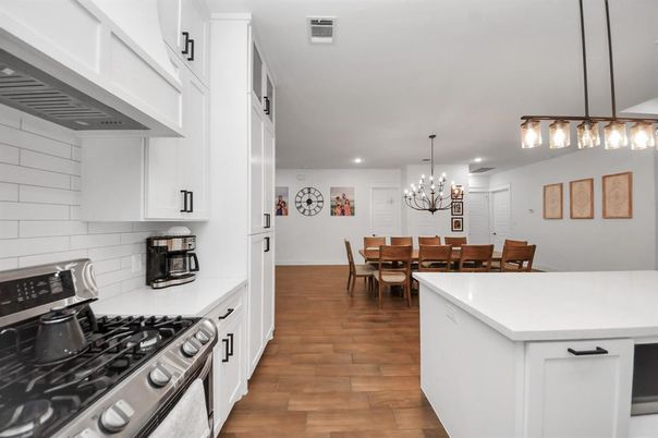 Chandelier, Dining room, Interior, Kitchen, Recessed Lighting, Stainless Steel Appliances, Wood Texture Flooring